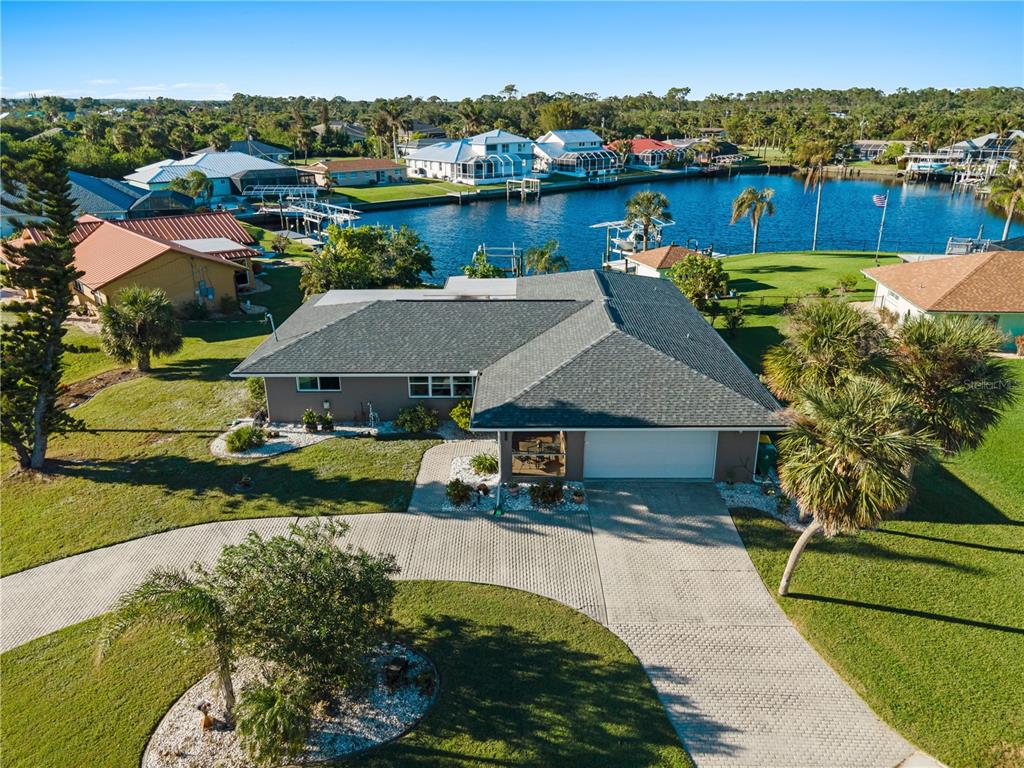 an aerial view of a house with a yard basket ball court and outdoor seating