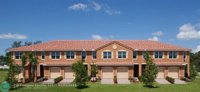 a front view of a house with yard and green space