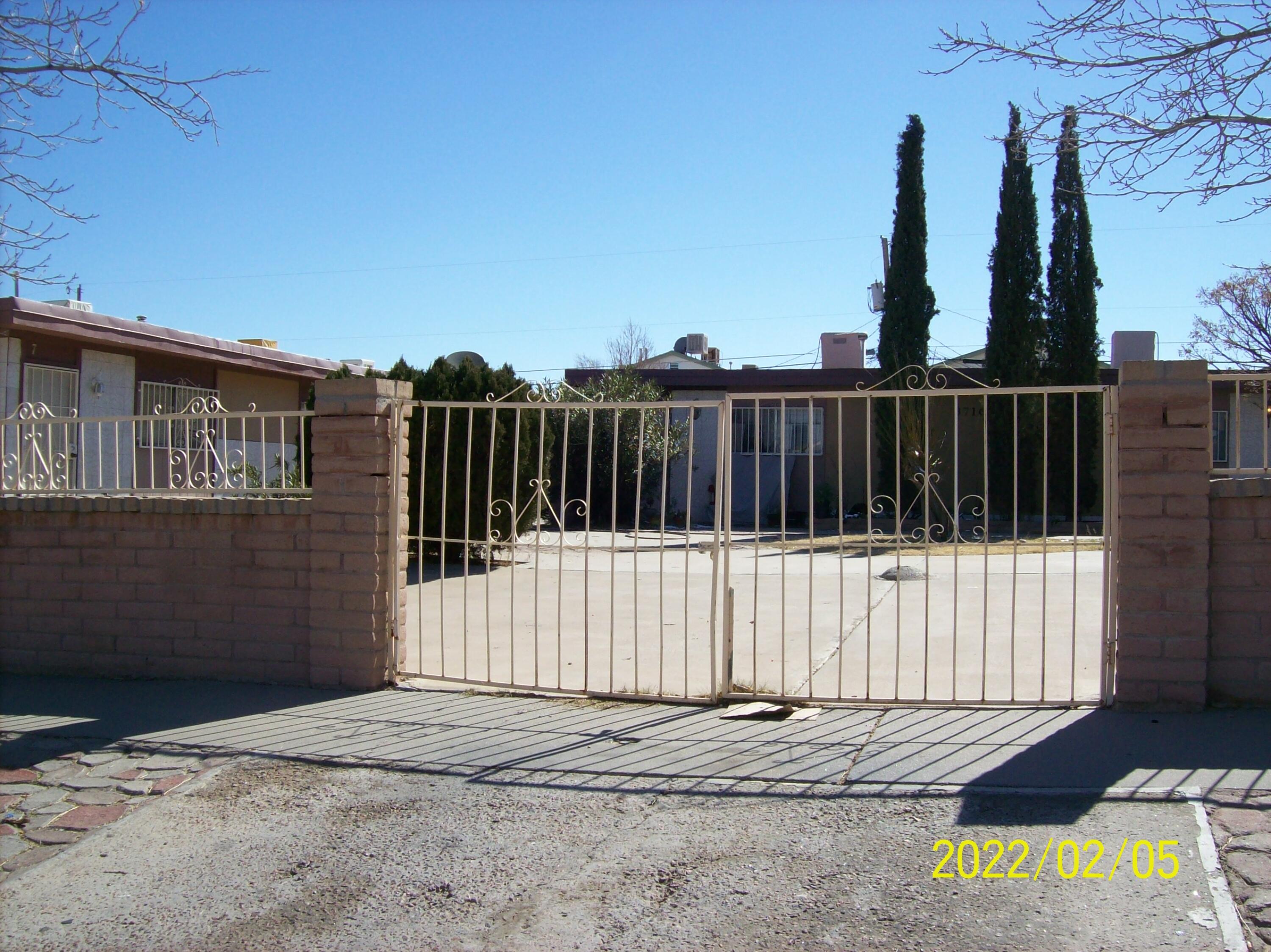 a view of a building with wooden fence