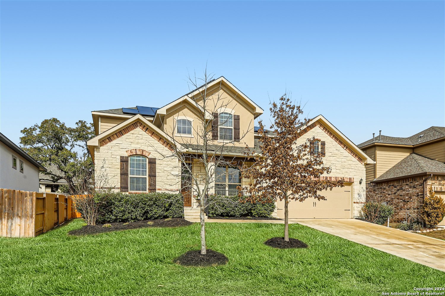 a front view of a house with a yard