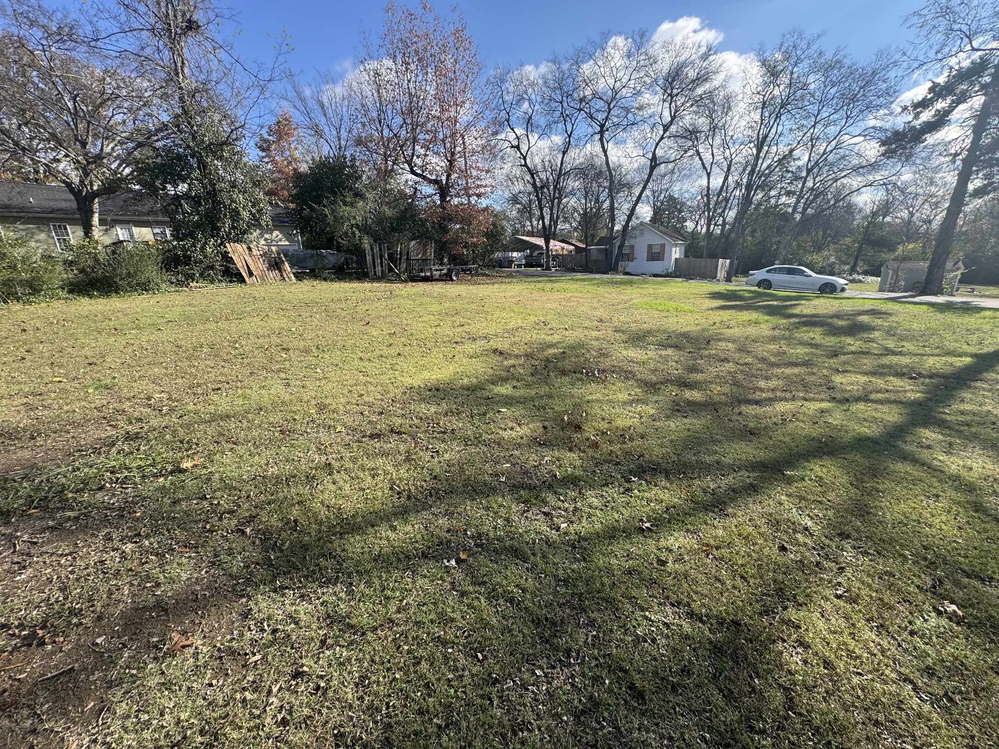 a view of a big yard with trees