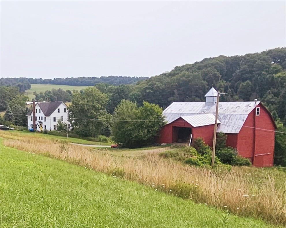 View of yard featuring a rural view and an outbuilding