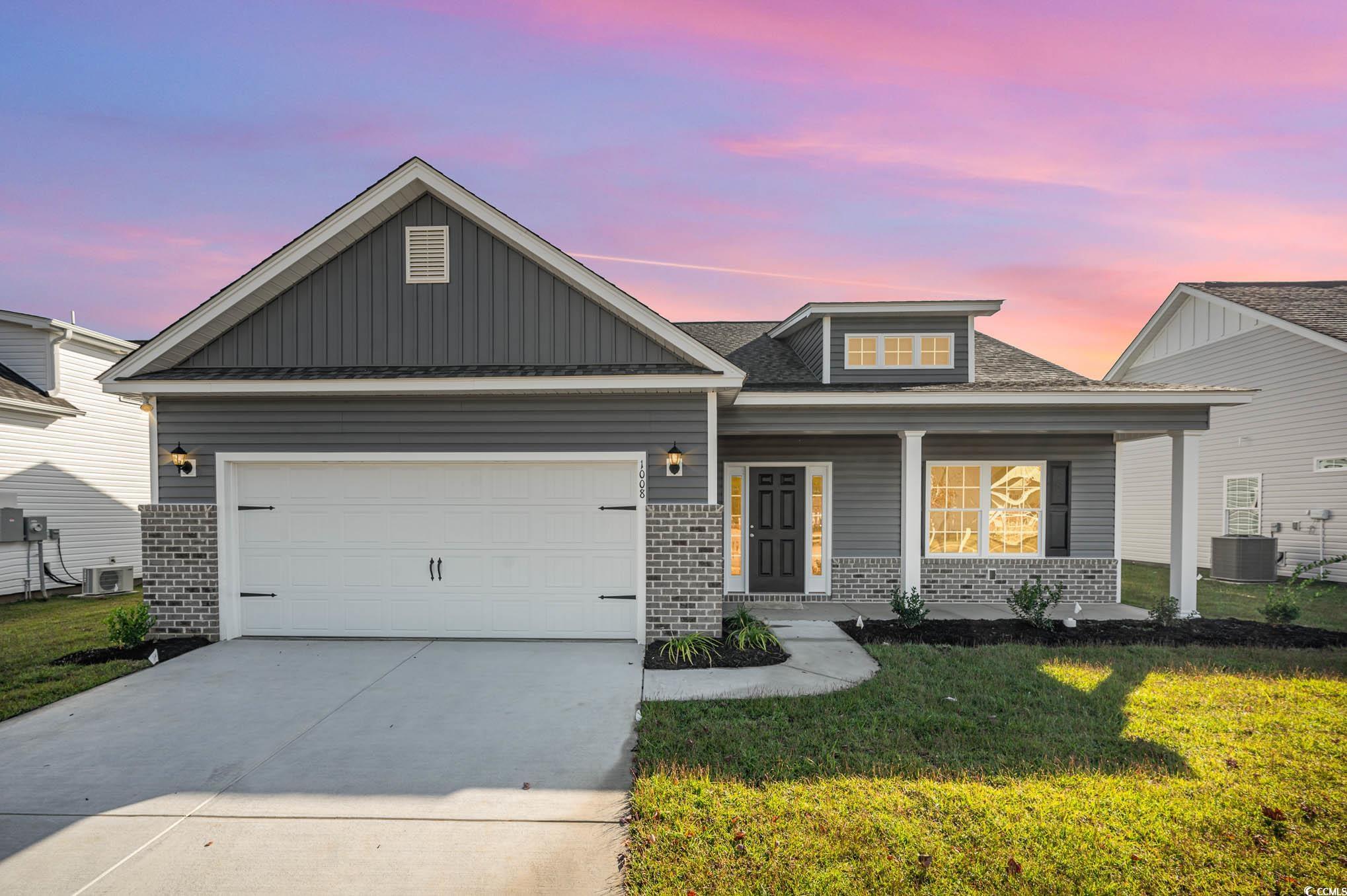 Craftsman house with a lawn, central AC unit, and