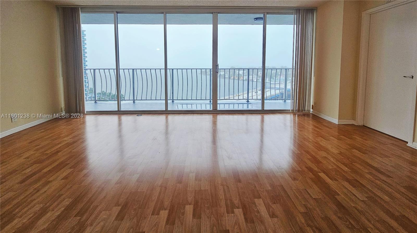 a view of wooden floor and windows in a room