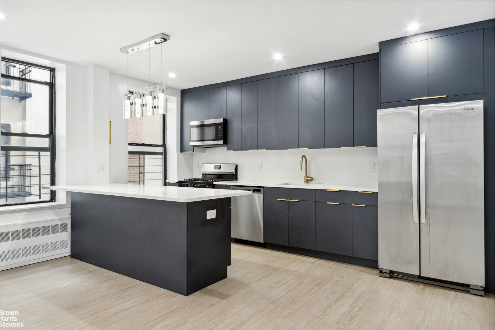 a kitchen with stainless steel appliances granite countertop a refrigerator and a sink