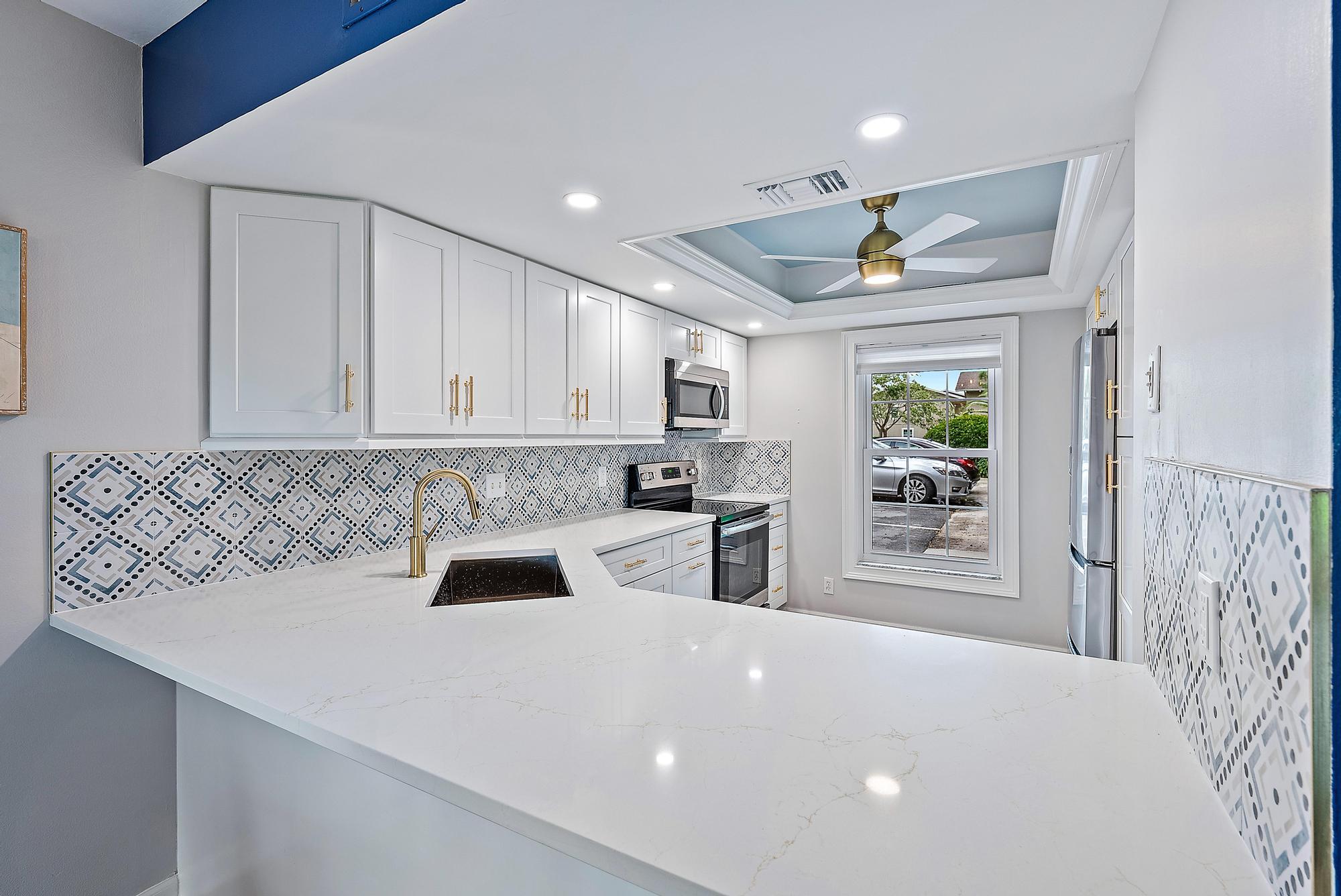 a kitchen with a sink cabinets and window