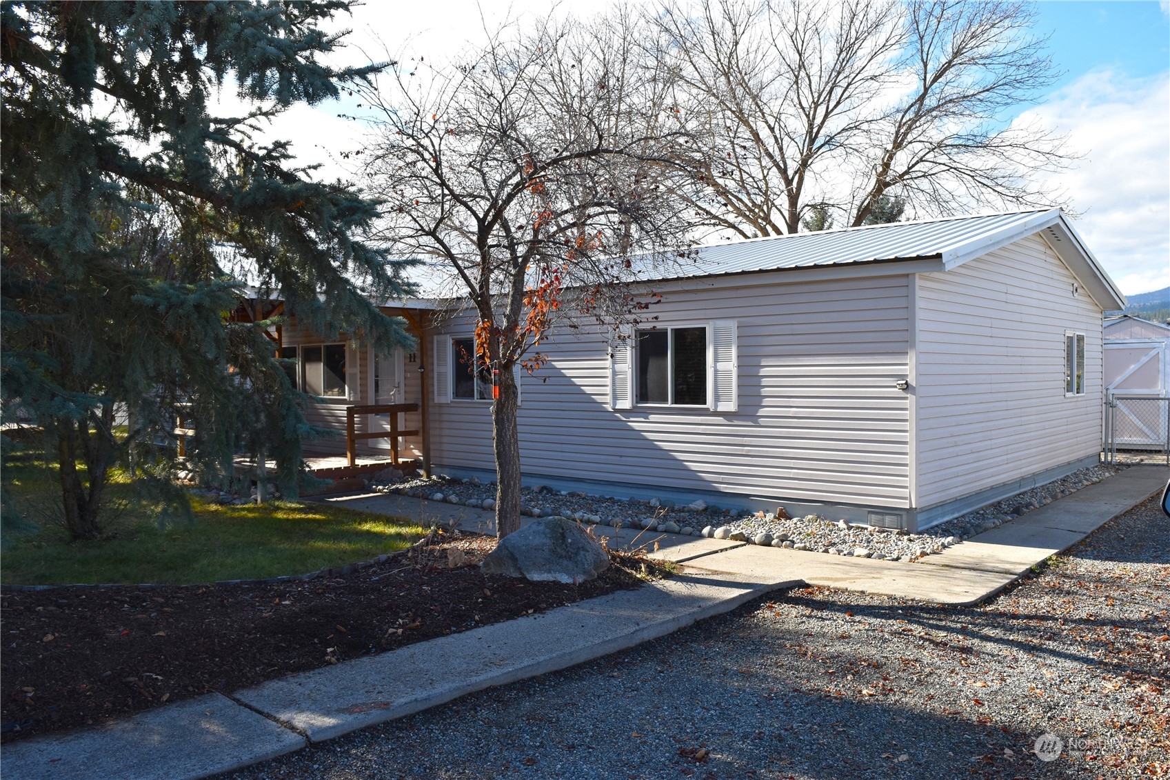 a front view of a house with yard and tree s