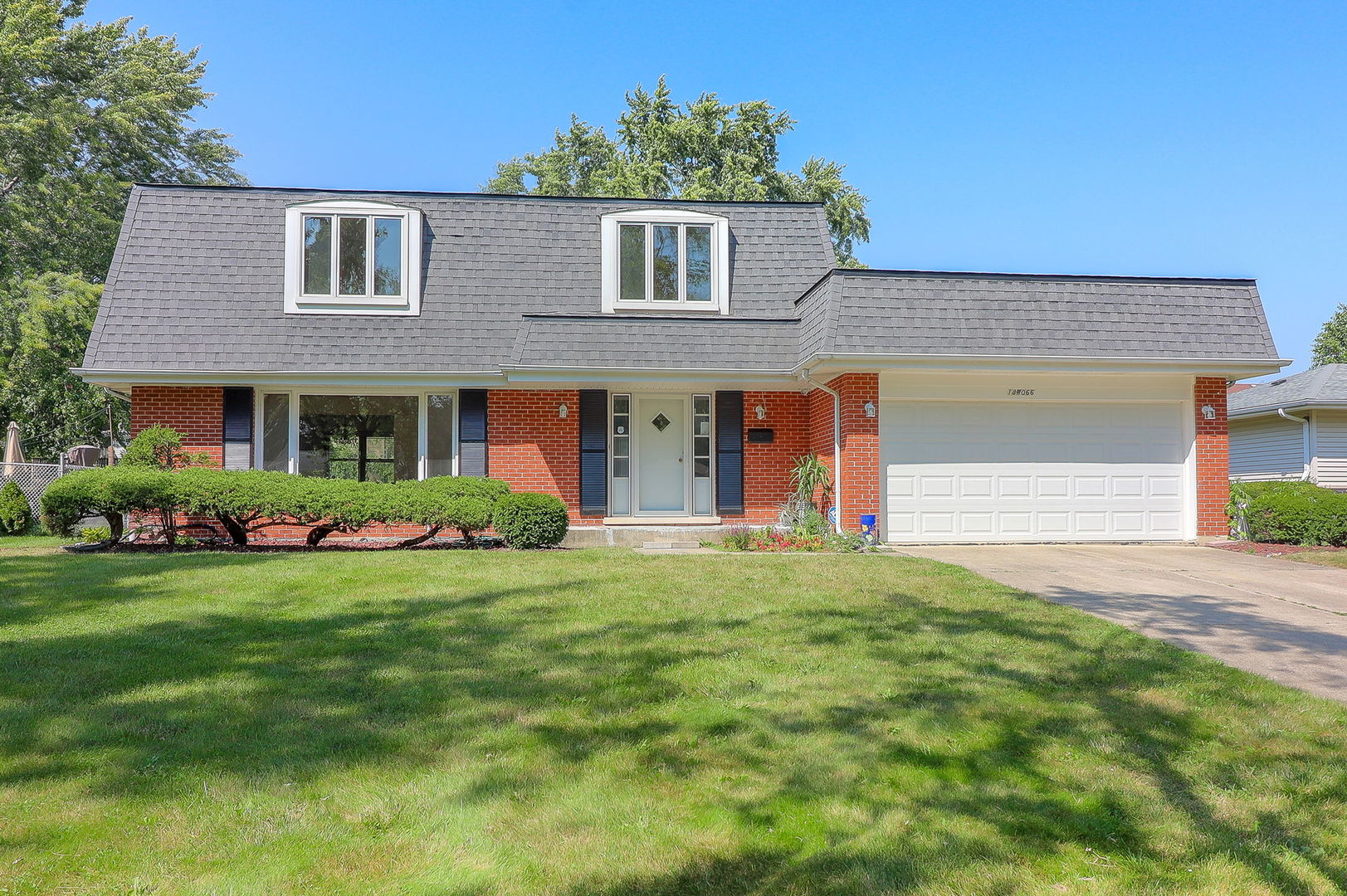 front view of a house with a garden