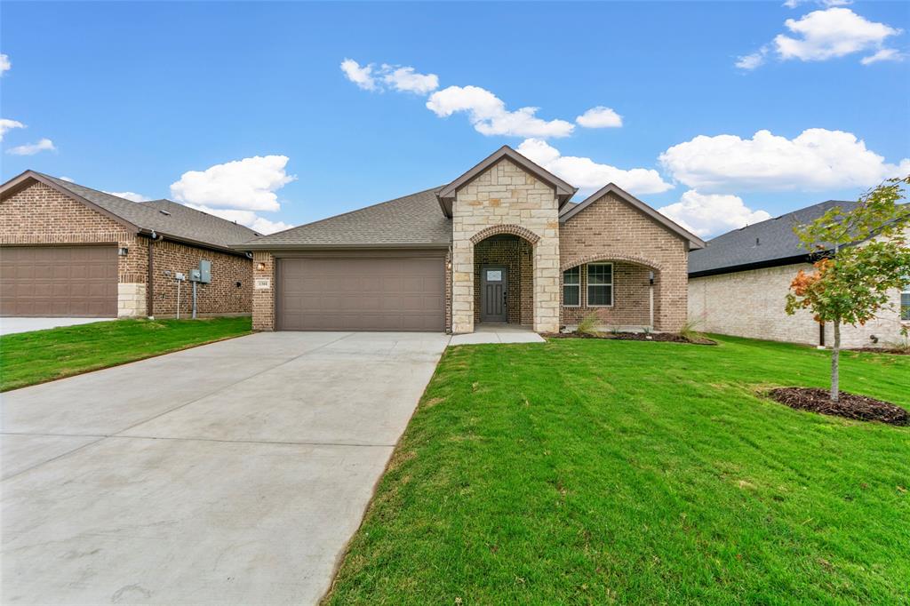 a front view of a house with a yard and garage