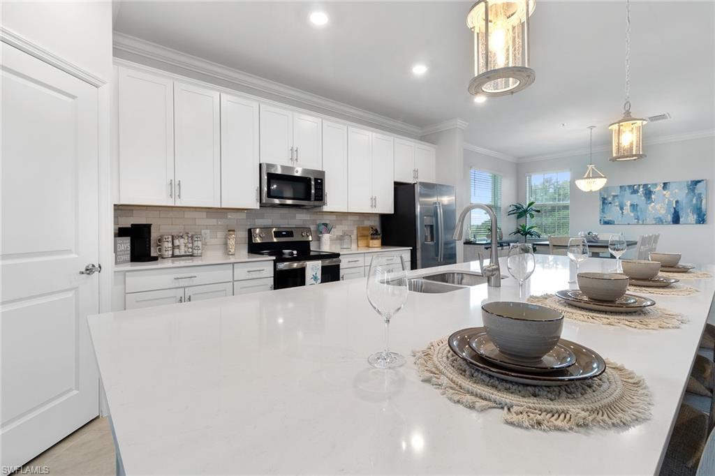 a kitchen with a refrigerator a stove a microwave and cabinets