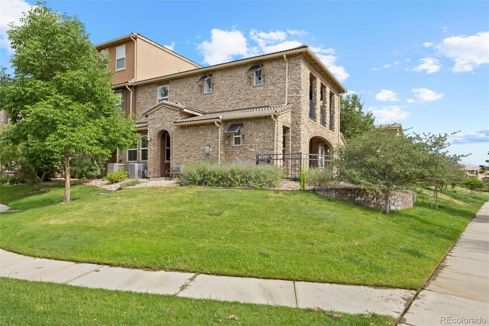 a front view of a house with garden