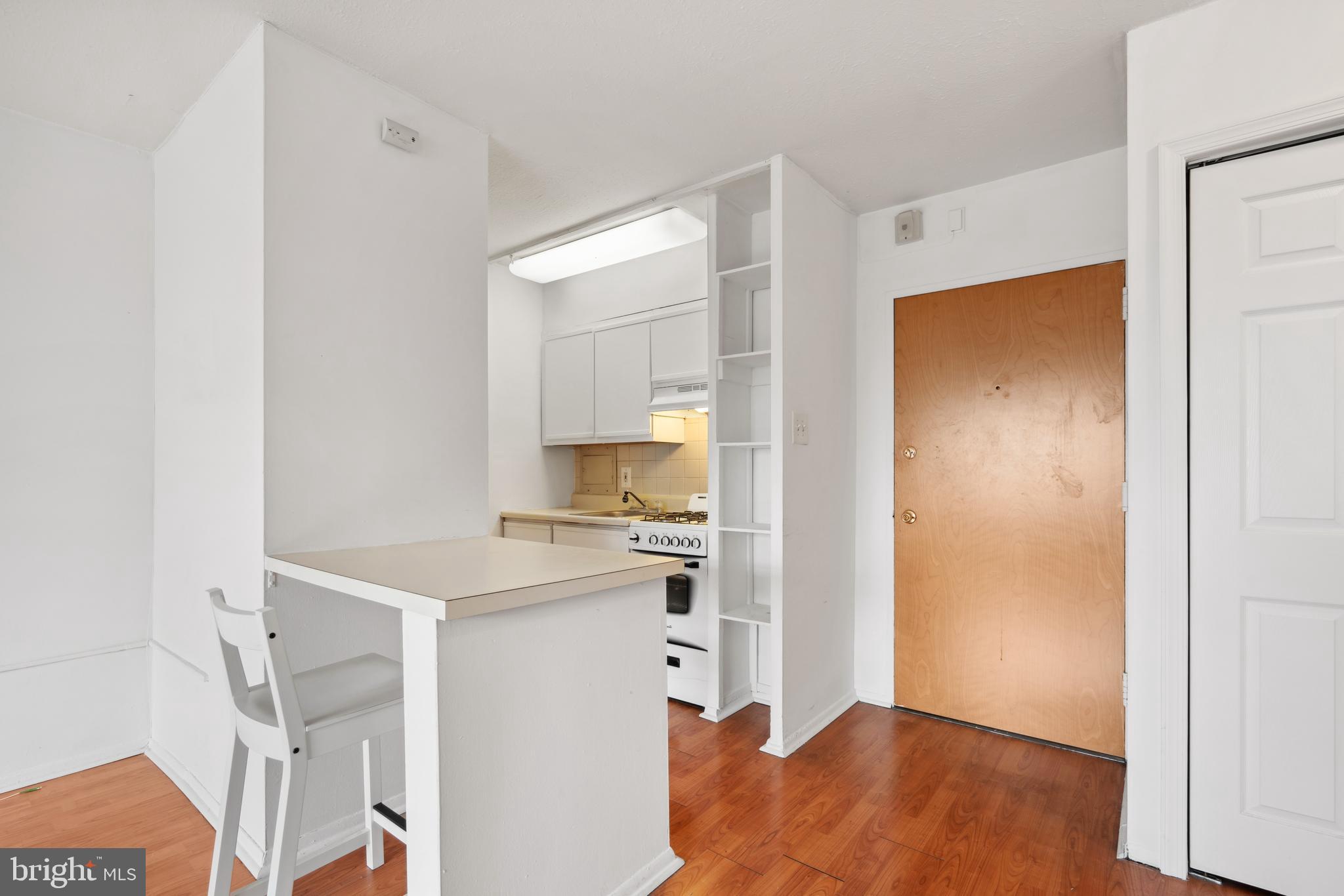 a kitchen with a refrigerator and a stove top oven