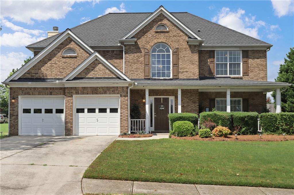 a front view of a house with a yard