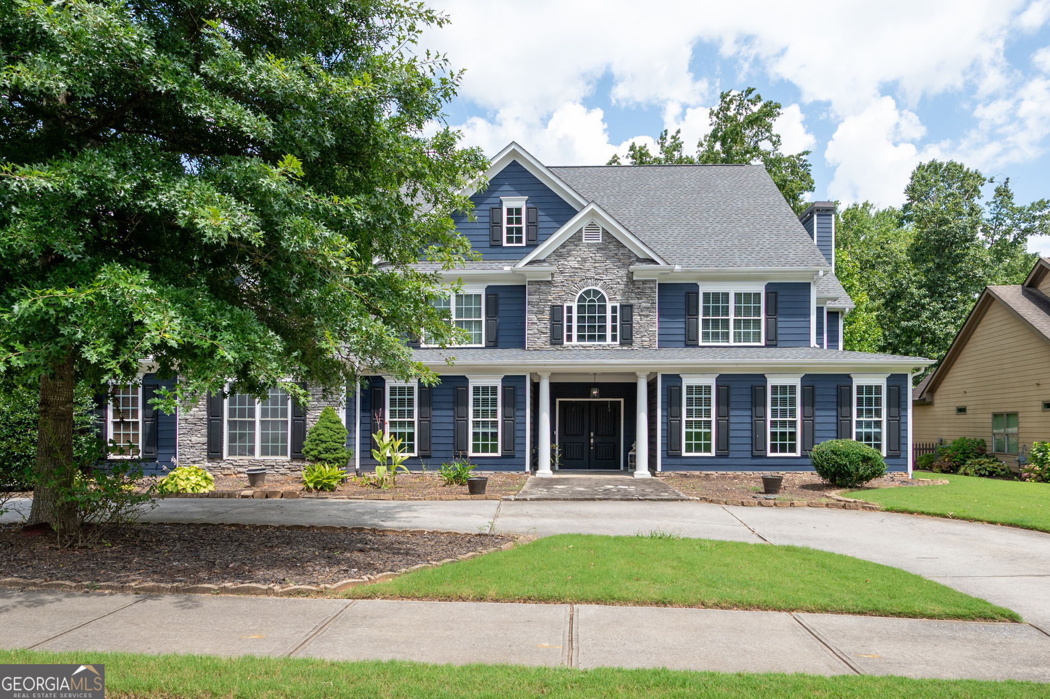 a front view of a house with a yard