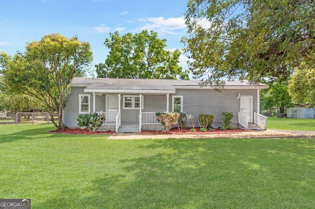 a house that has a big yard with big trees