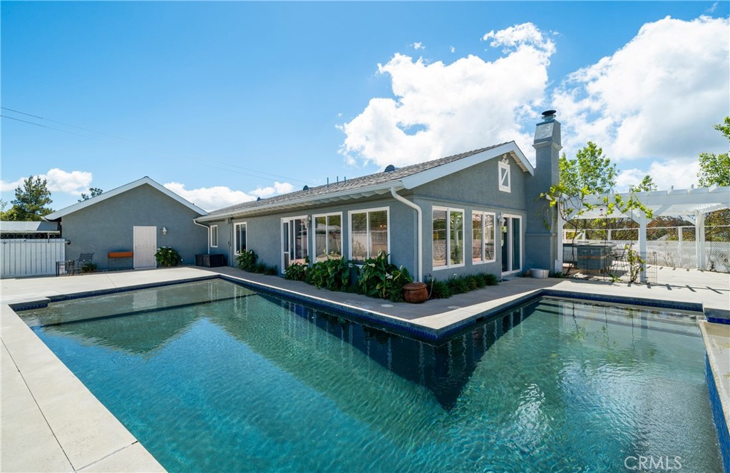 a view of a house with swimming pool and a yard