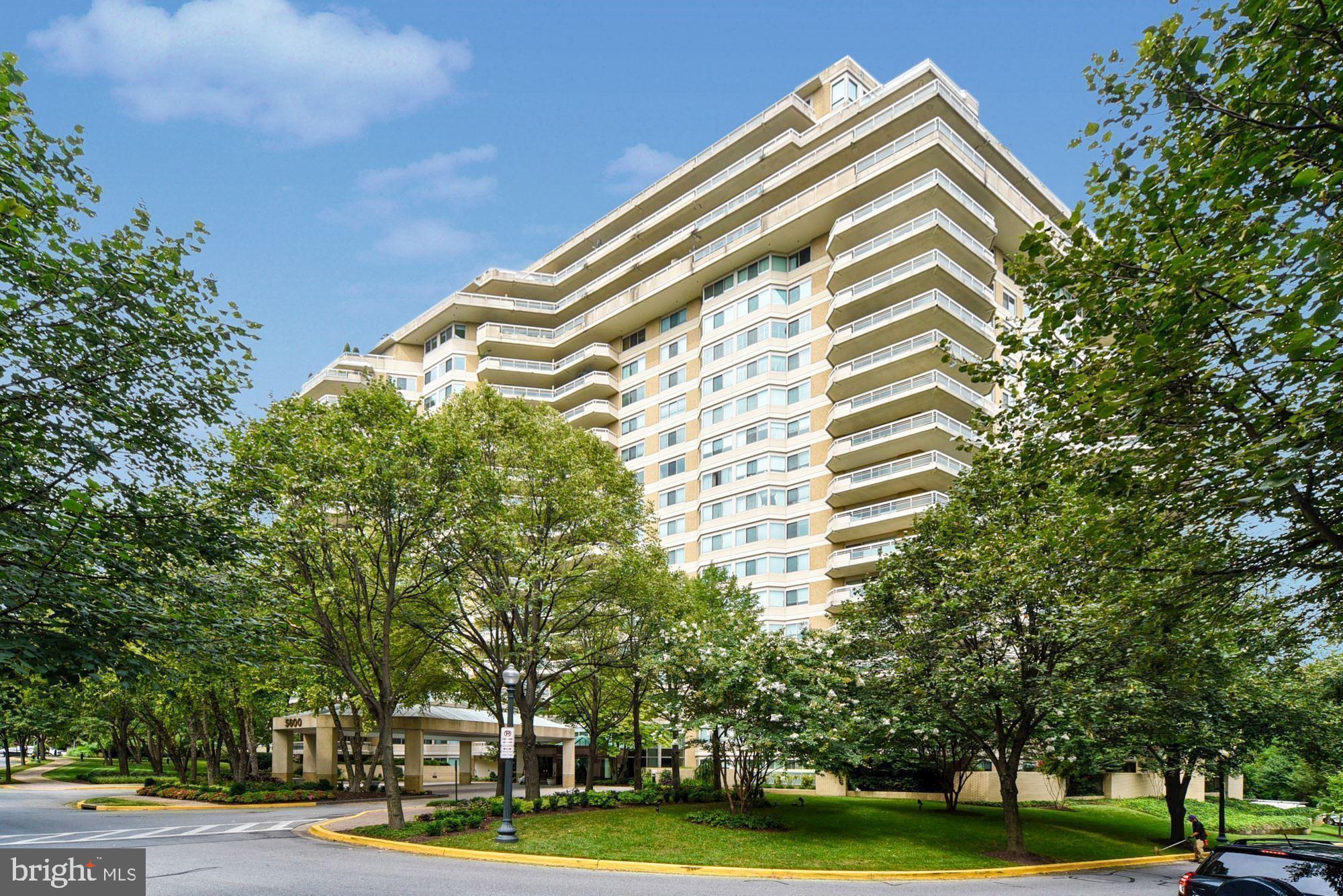 a front view of a building with trees