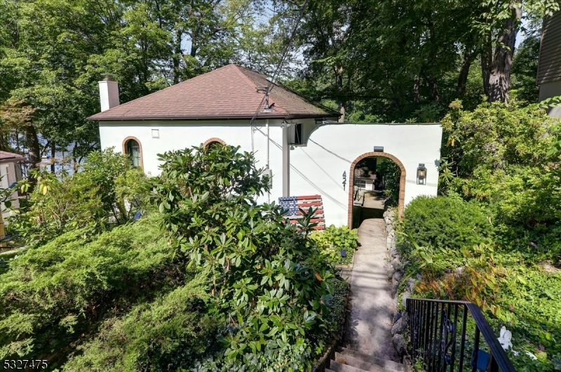 an aerial view of a house with garden space and a street view