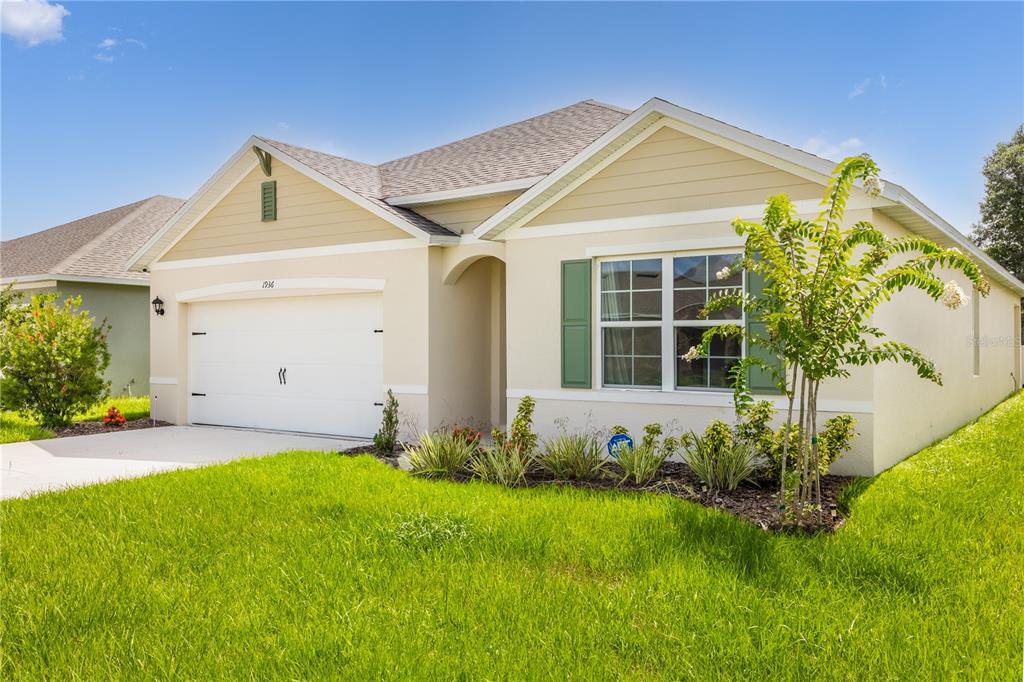 a front view of a house with a yard and garage