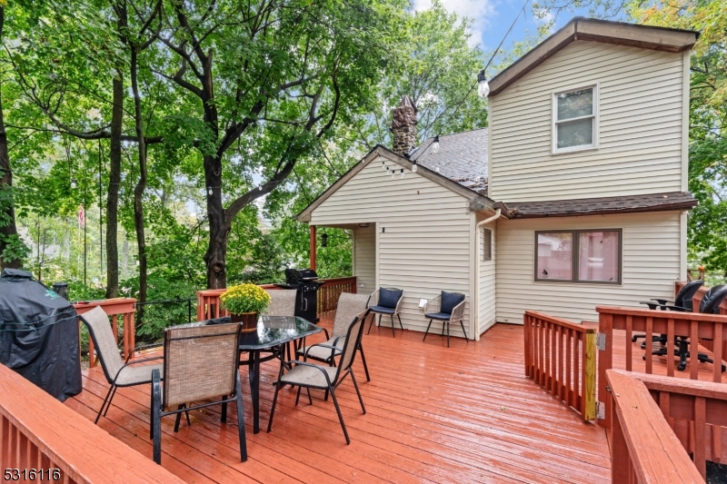 a view of a patio with table and chairs and wooden floor