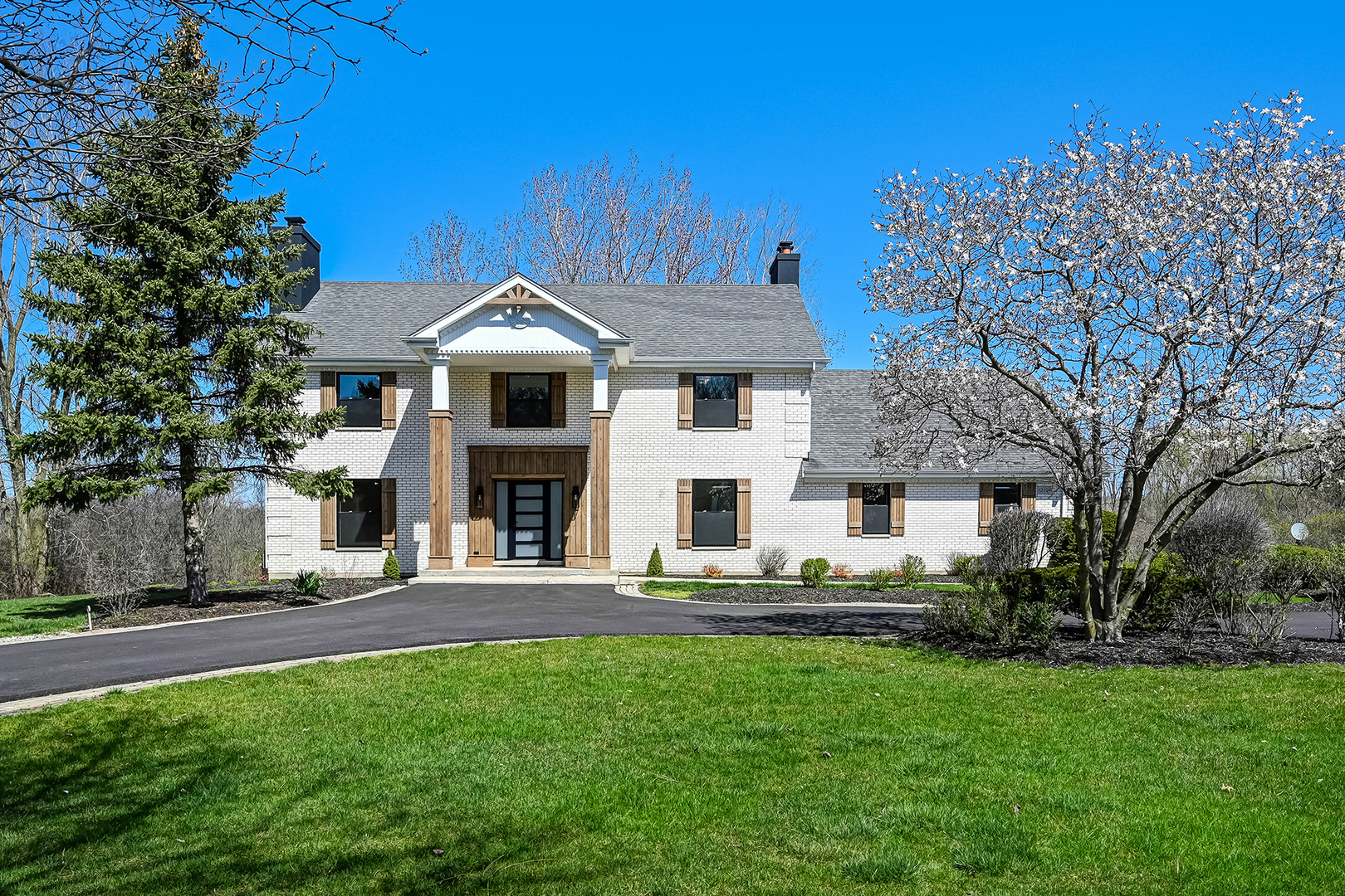 a front view of a house with a yard