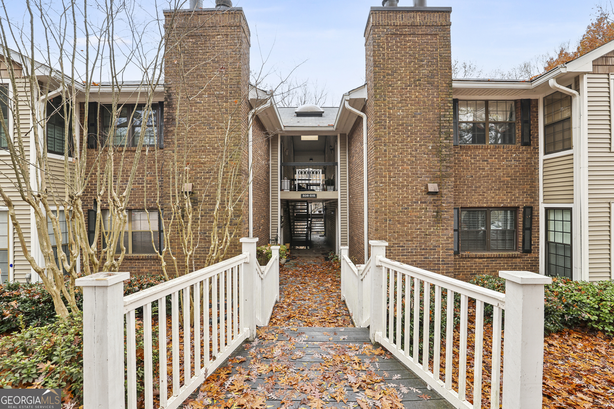 a view of a brick house with large windows