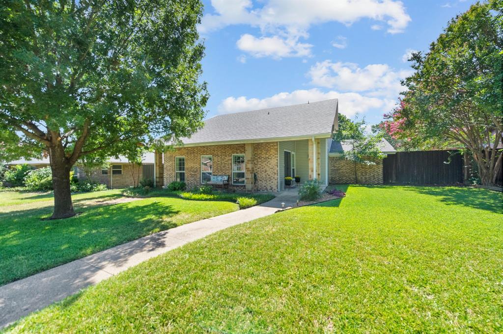 a view of a house with a yard and tree s