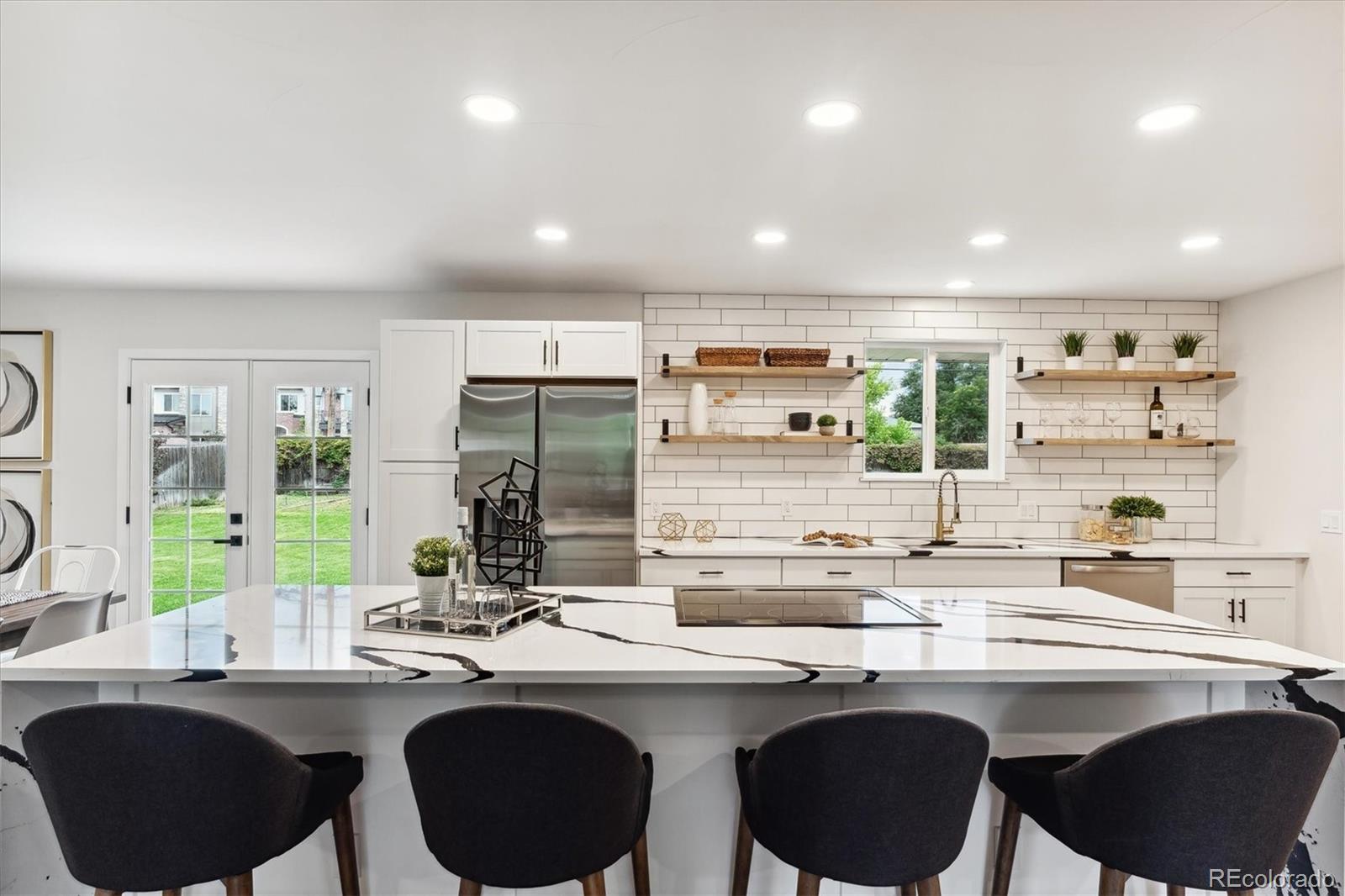 a kitchen with a sink and chairs