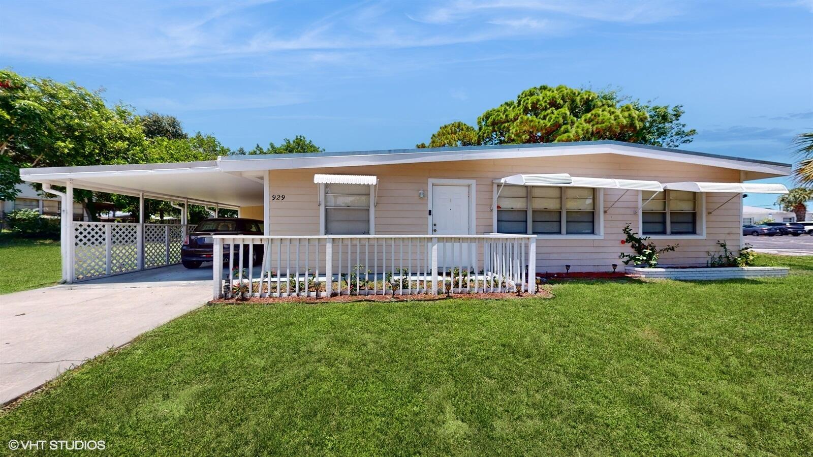 a view of a house with a backyard and a patio