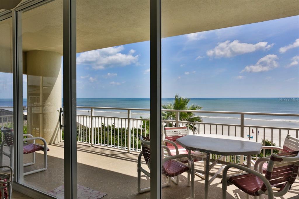 a view of a balcony with a table and chairs