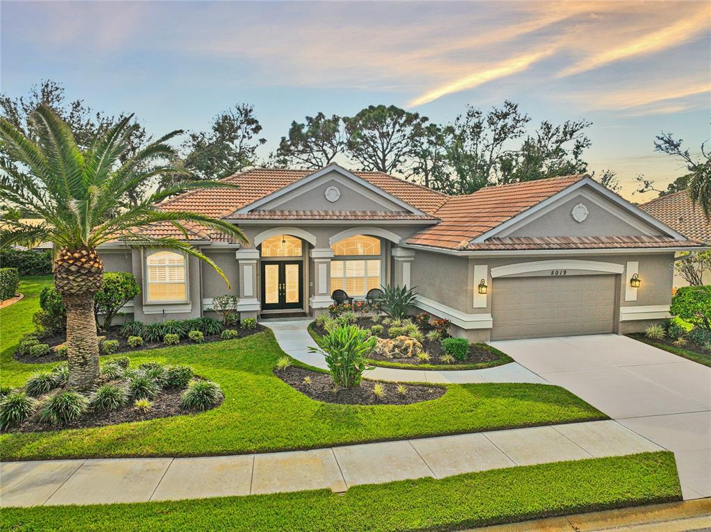 a front view of a house with a garden