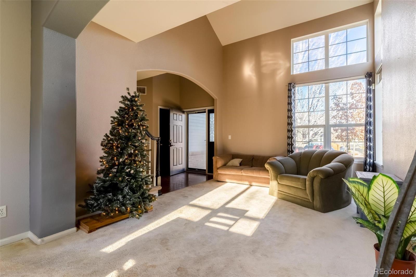 a living room with furniture and a potted plant