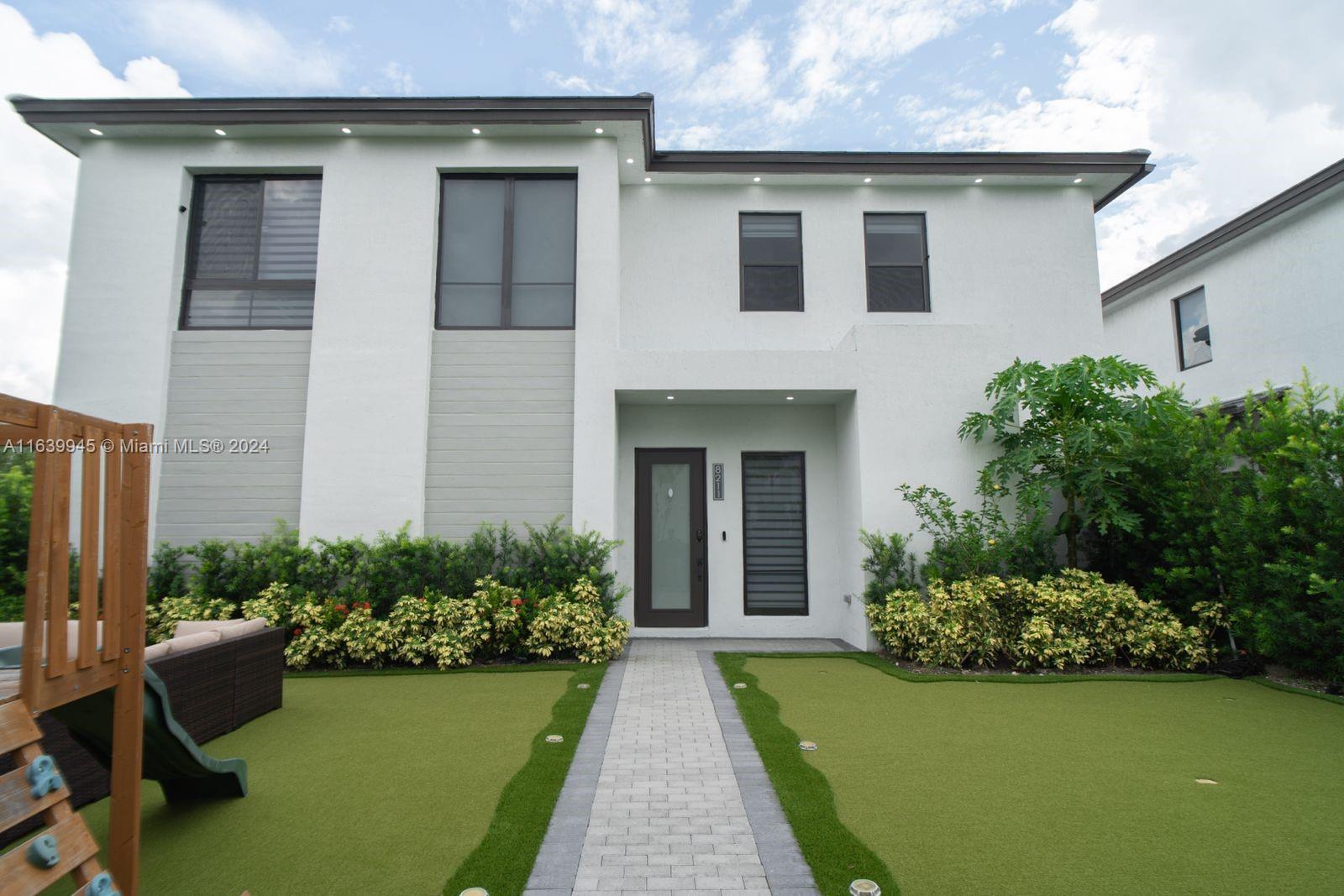 a front view of a house with garden