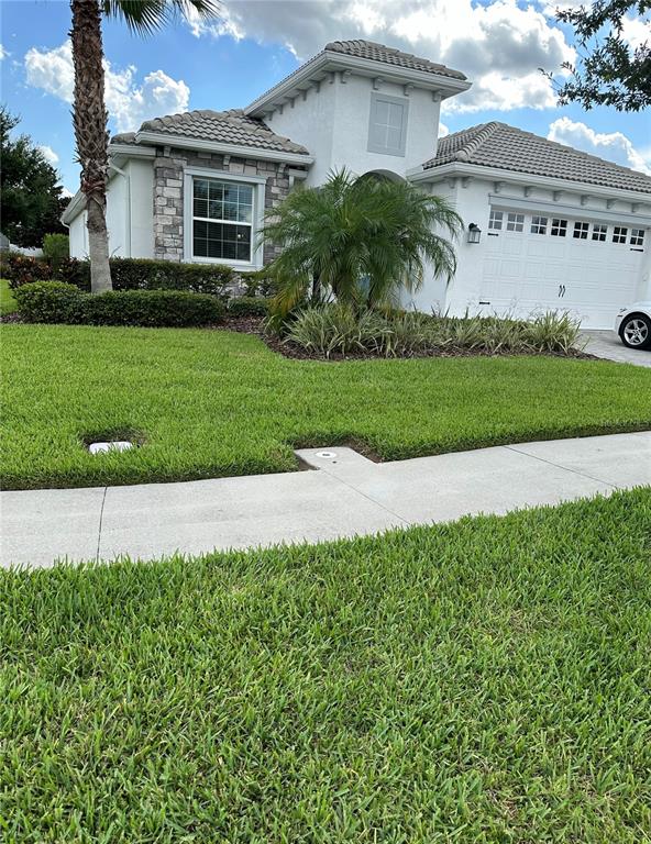 a front view of a house with a yard and garage