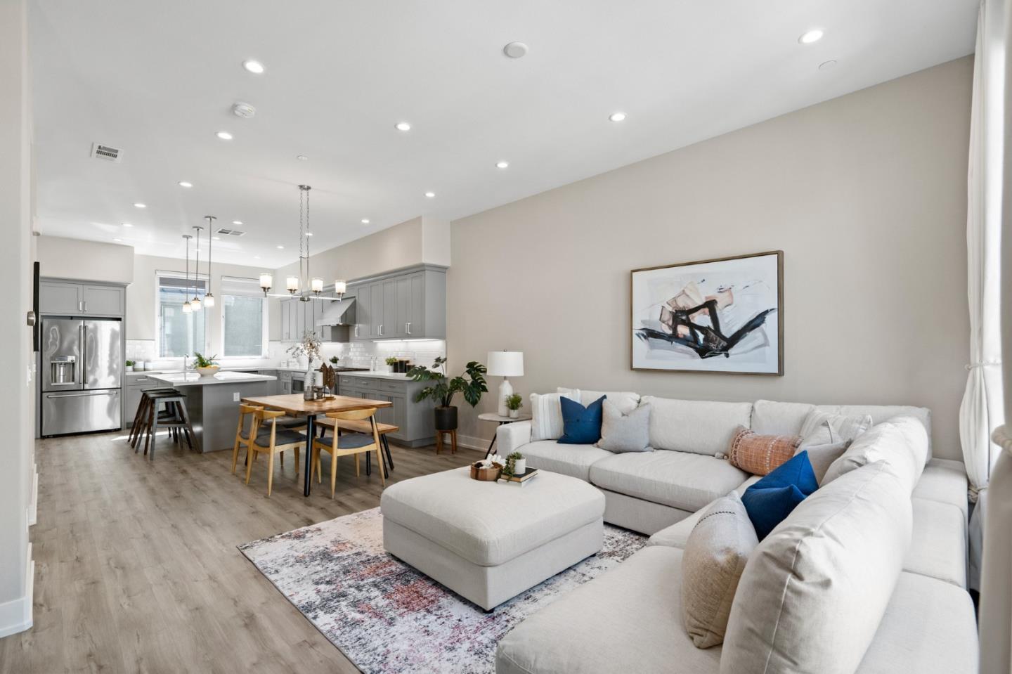 a living room with furniture and view of kitchen