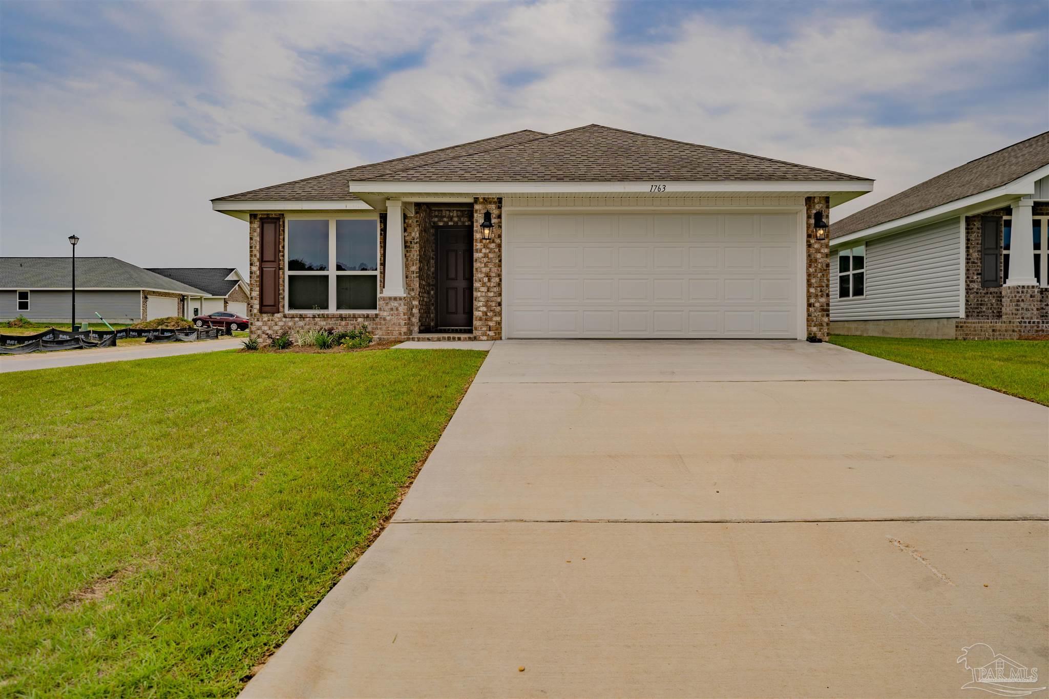 a front view of a house with yard