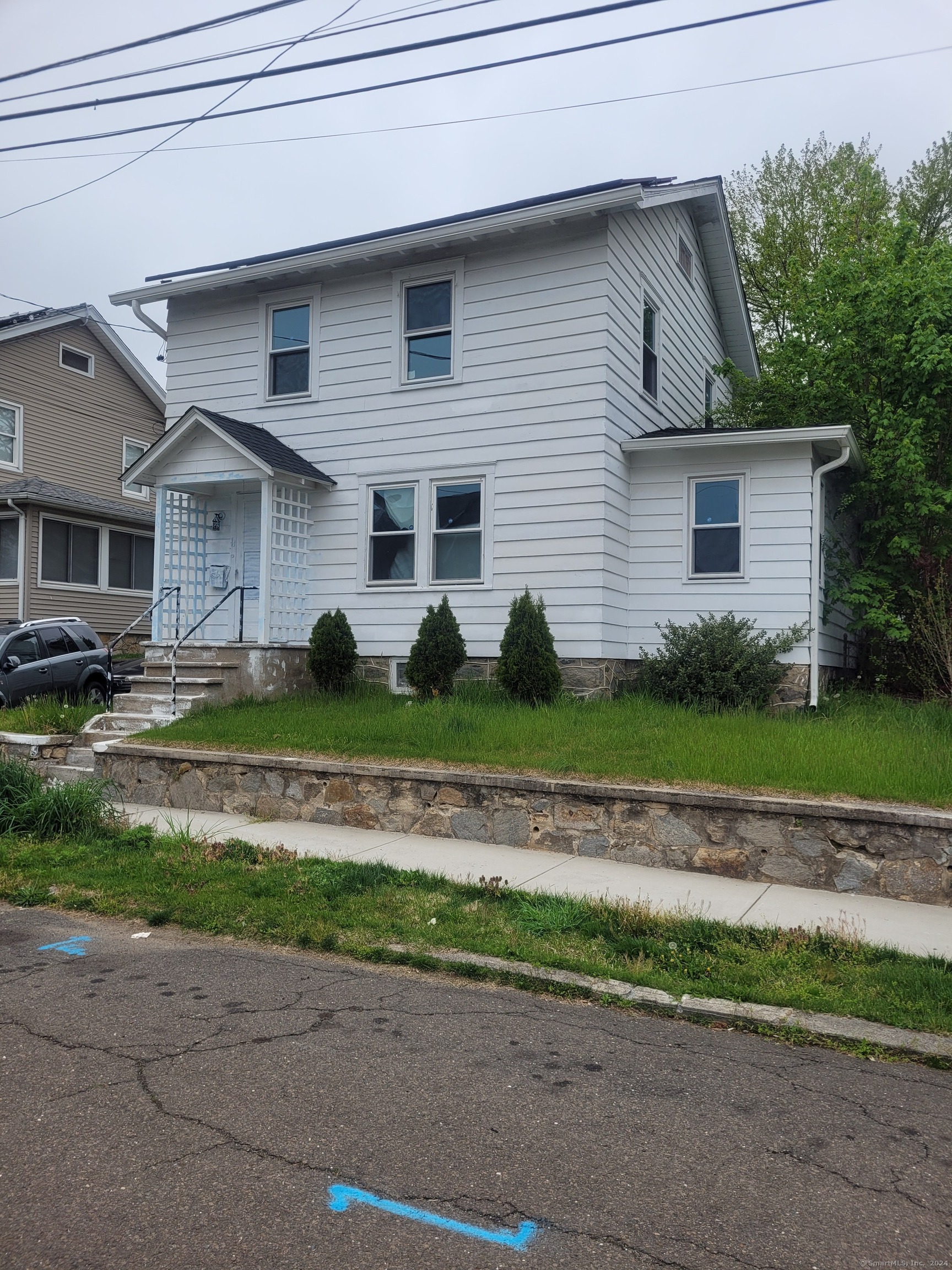 a front view of a house with a garden