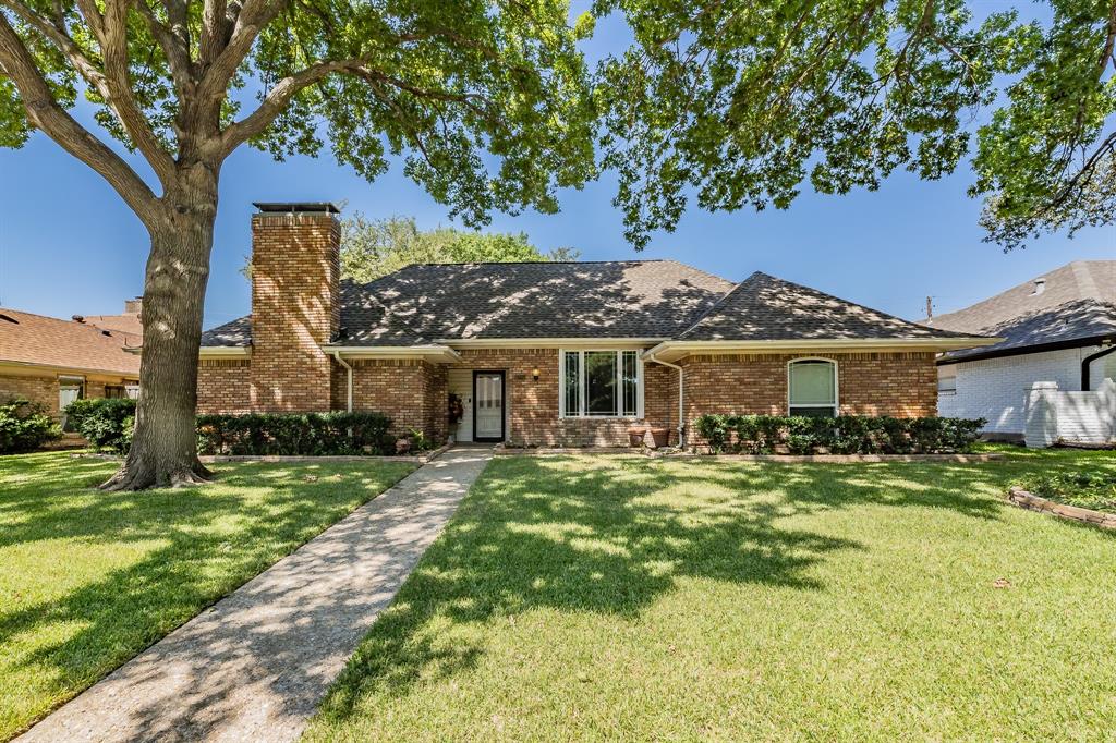 Ranch-style home featuring a front yard