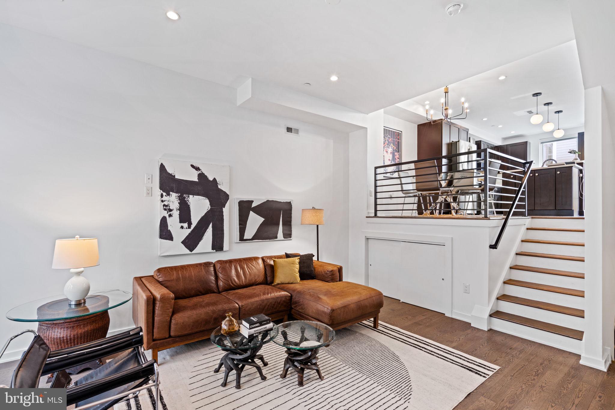 a living room with furniture and wooden floor