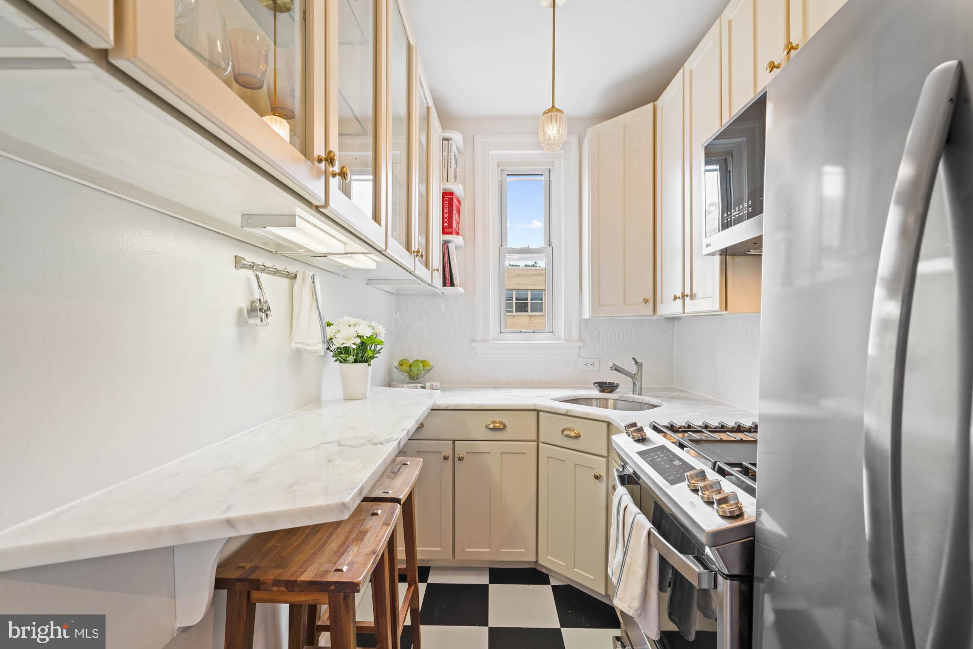 a kitchen with a stove a sink and a refrigerator