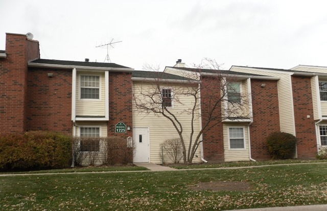 a view of a house with brick walls