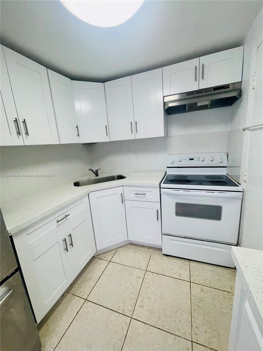 a kitchen with cabinets and appliances