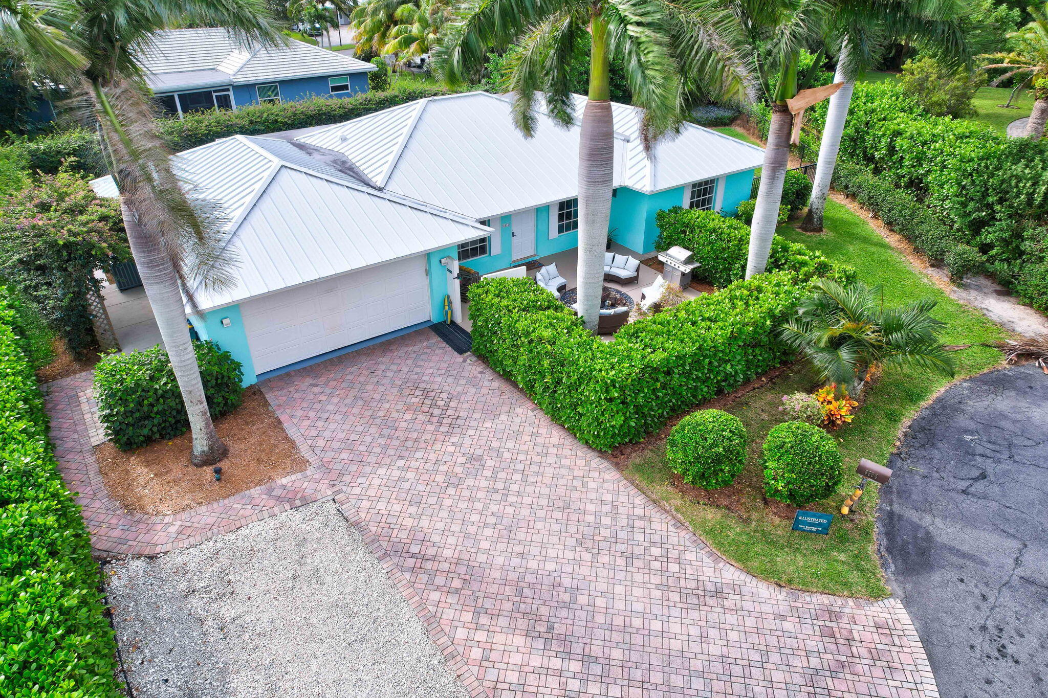 a view of a house with a yard and potted plants