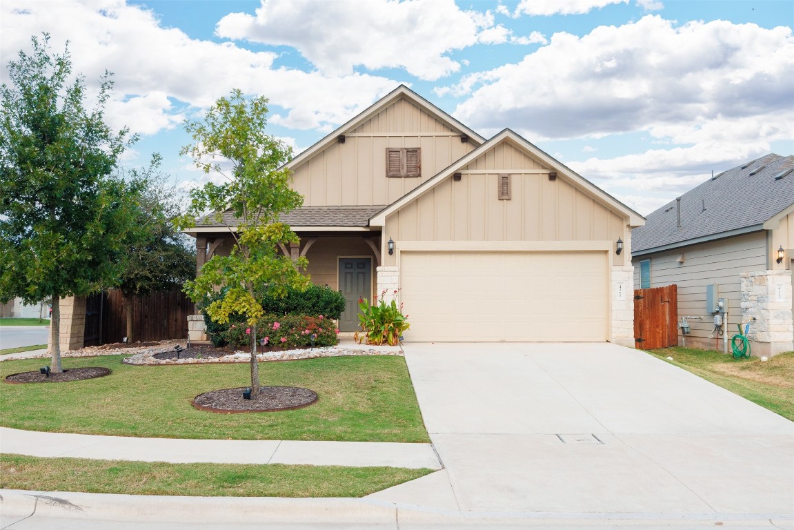 a front view of a house with a yard garage and garage