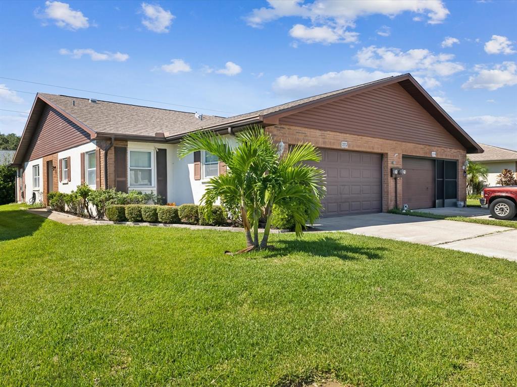 a front view of house with yard and green space