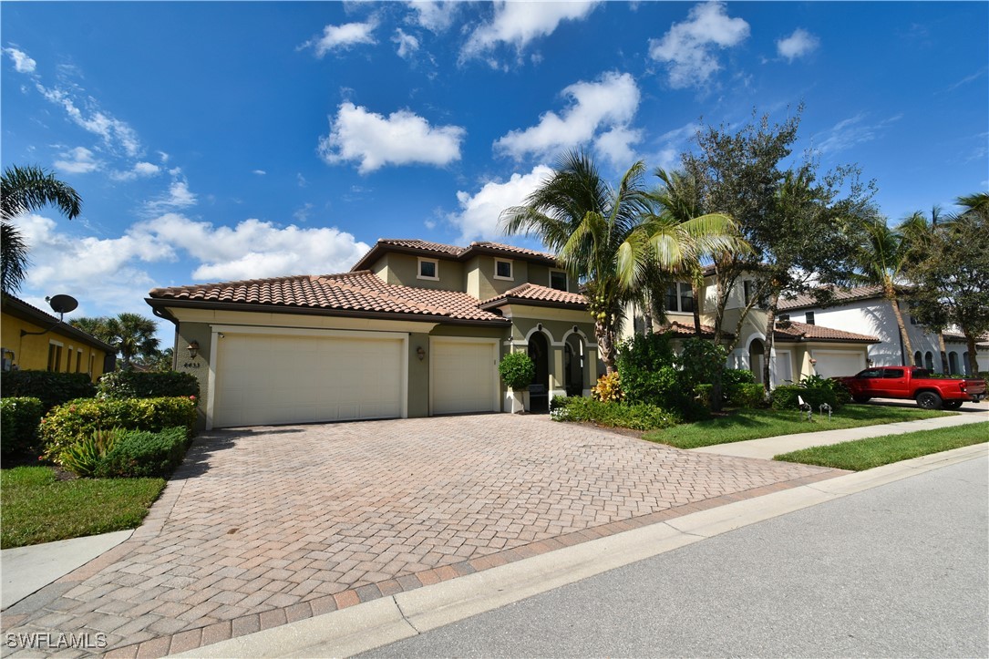 a front view of a house with a yard and garage