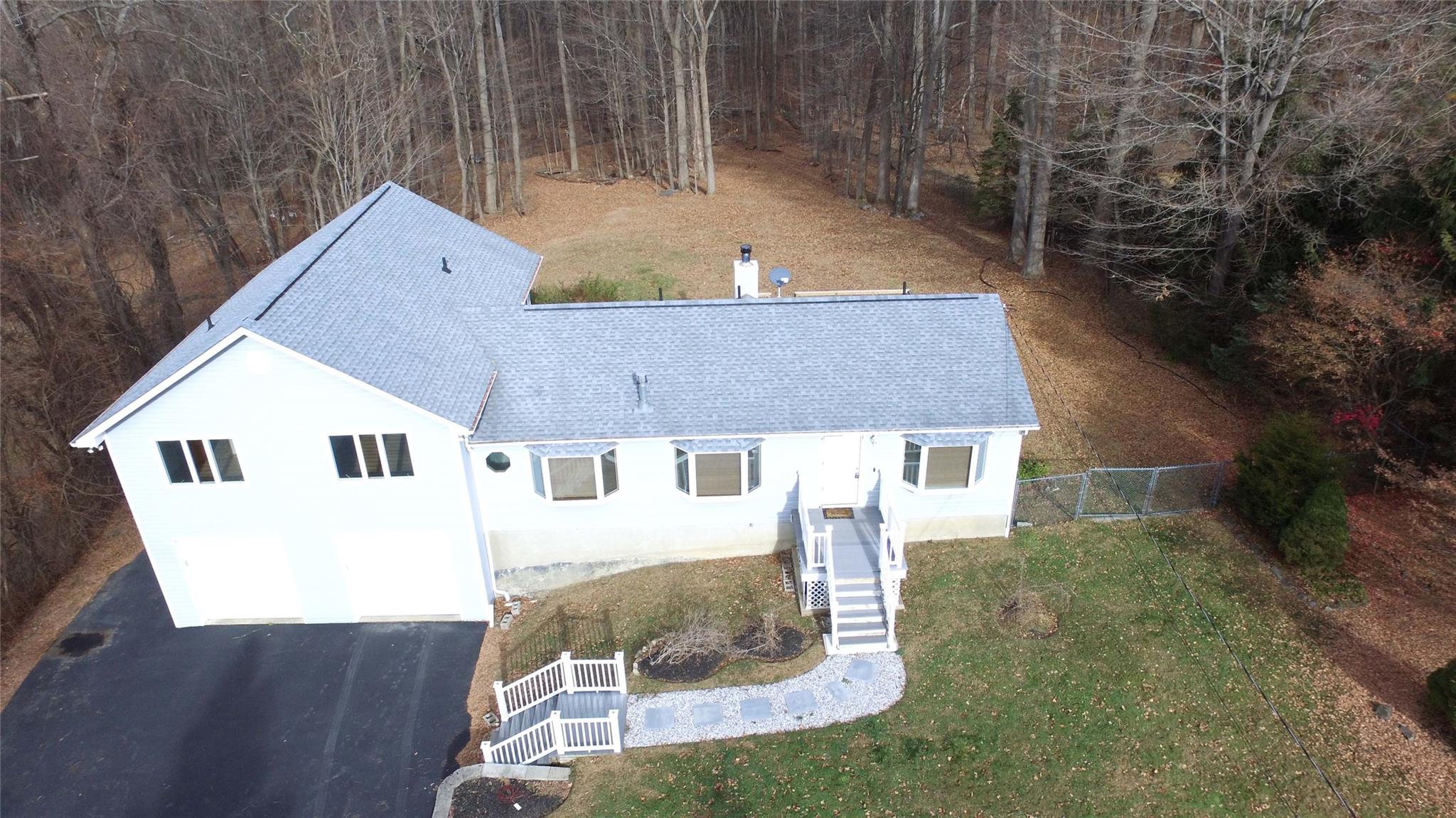 an aerial view of a house with yard