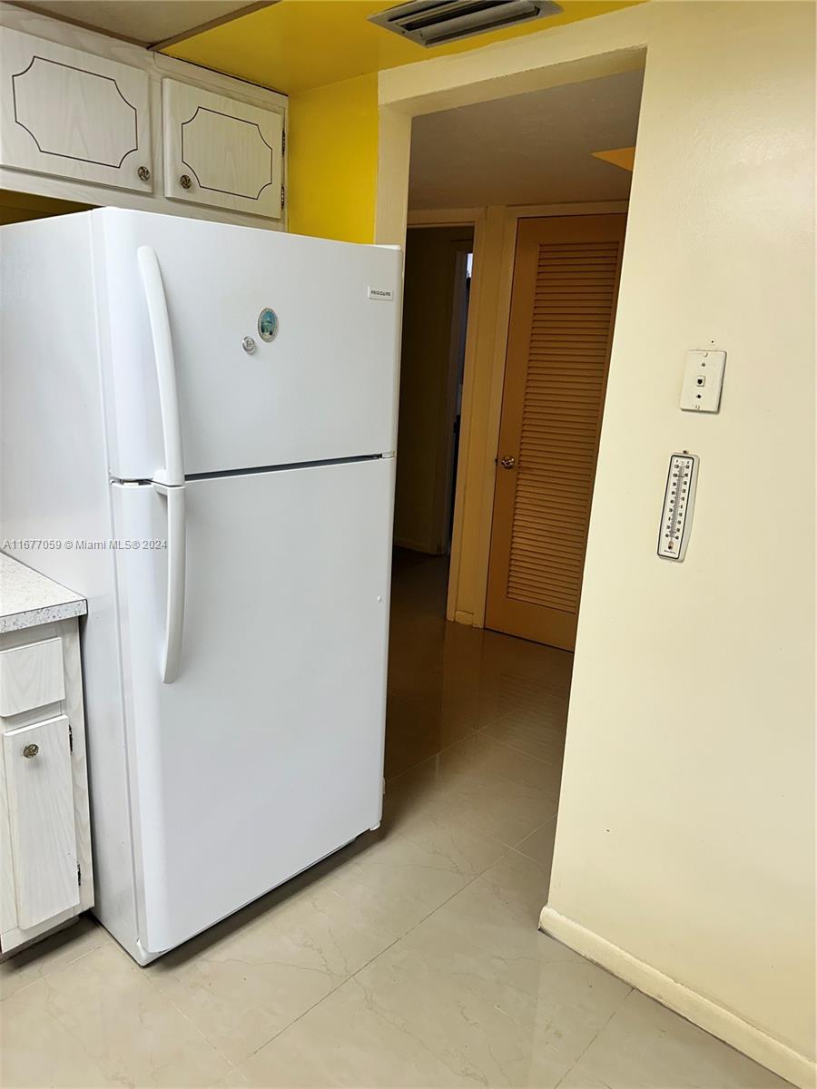 a white refrigerator freezer and a dishwasher