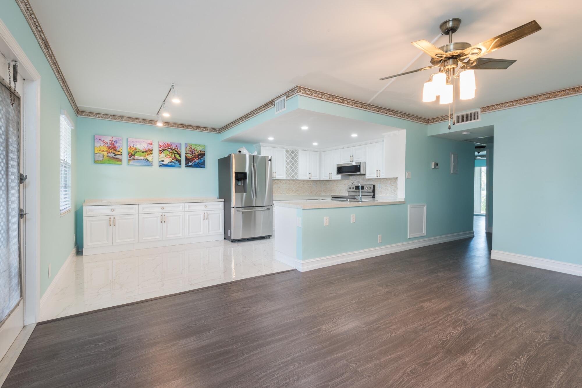 a view of a kitchen with a dishwasher cabinets and wooden floor