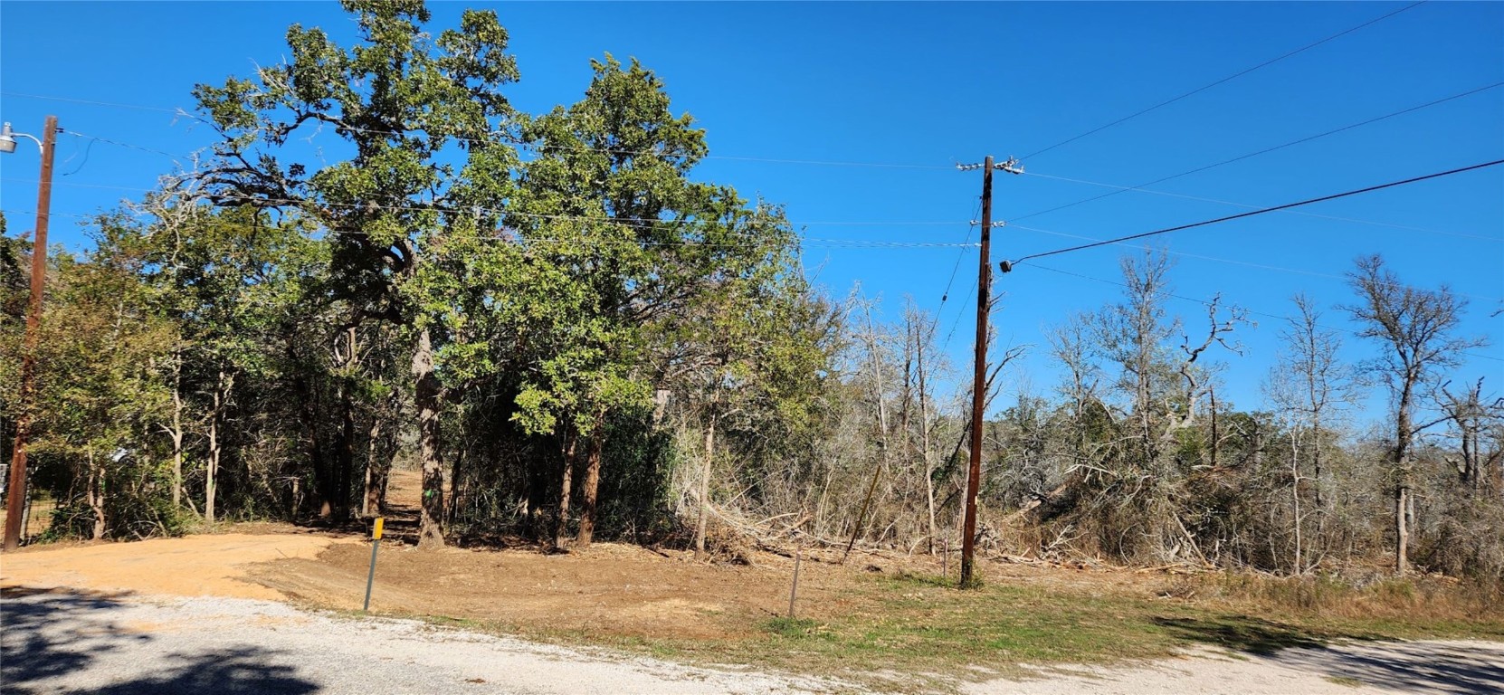 Lot's front showing newly installed culvert and driveway with road-base material.